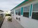 Exterior view of home showing white rock landscaping and updated vinyl siding at 4802 Brae Burn Ave, Sarasota, FL 34234