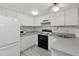 Efficient kitchen featuring a white refrigerator, microwave, and ample counter space for cooking needs at 4802 Brae Burn Ave, Sarasota, FL 34234
