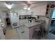 A charming kitchen featuring white cabinetry, updated appliances, a breakfast bar and a stainless sink at 4802 Brae Burn Ave, Sarasota, FL 34234