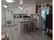 Well-lit kitchen with white cabinets, breakfast bar, and modern appliances offers a functional cooking space at 4802 Brae Burn Ave, Sarasota, FL 34234