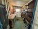 Functional utility room featuring a washer, dryer, storage shelves, and a workbench at 4802 Brae Burn Ave, Sarasota, FL 34234