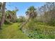 Backyard with a pond and palm trees at 32971 Serene Dr, Punta Gorda, FL 33982