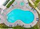 Aerial view of a beautifully designed swimming pool and lush surroundings at 1709 N Tamiami Trl # 403, Sarasota, FL 34234