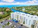 Aerial view of the waterfront apartment complex with covered parking and coastal views at 1709 N Tamiami Trl # 403, Sarasota, FL 34234