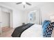 Bright bedroom features natural light, ceiling fan, wood floors, and blue decorative pillows at 1709 N Tamiami Trl # 403, Sarasota, FL 34234