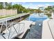 Waterfront property featuring a private dock with boat lift access for easy boating at 1709 N Tamiami Trl # 403, Sarasota, FL 34234