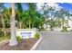 A lovely entrance to The Strand condo complex, surrounded by palm trees at 1709 N Tamiami Trl # 403, Sarasota, FL 34234