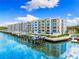 Beautiful waterfront apartment complex with boat docks on a sunny day with a blue sky and white clouds at 1709 N Tamiami Trl # 403, Sarasota, FL 34234