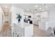 Modern, all-white kitchen with stainless steel appliances, quartz countertops, and bar seating at 1709 N Tamiami Trl # 403, Sarasota, FL 34234