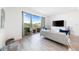 Bright living room with sliding glass doors, light wood floors, and stylish neutral furniture at 1709 N Tamiami Trl # 403, Sarasota, FL 34234