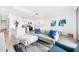 Open-concept living space with a kitchen, sofa, and natural light in a modern design at 1709 N Tamiami Trl # 403, Sarasota, FL 34234