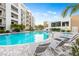 Resort-style pool area with ample seating and lush landscaping at this condo at 1709 N Tamiami Trl # 403, Sarasota, FL 34234