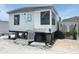 Exterior view of raised single story home with white siding and small front porch at 3710 Gulf Of Mexico Dr # E3, Longboat Key, FL 34228