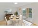 Bright dining area with table and chairs, leading to a private balcony at 8910 White Sage Loop, Lakewood Ranch, FL 34202