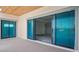 Covered balcony offering seamless access to waterfront views through blue-tinted impact windows at 3621 San Remo Ter, Sarasota, FL 34239