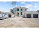 Expansive two-story home showcasing modern architecture with a spacious three-car garage and light gray roofing at 3621 San Remo Ter, Sarasota, FL 34239