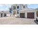 Beautiful two-story white home with a two-car garage, steps to front door, and gravel driveway at 3621 San Remo Ter, Sarasota, FL 34239