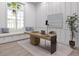 Bright home office features a built-in window seat, a modern desk, and neutral tones at 3621 San Remo Ter, Sarasota, FL 34239