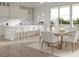 Charming kitchen with bar stool seating, stainless steel appliances, and a dining table with backyard views at 3621 San Remo Ter, Sarasota, FL 34239