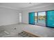 Spacious living room featuring sliding glass doors, tray ceiling and access to water views at 3621 San Remo Ter, Sarasota, FL 34239