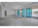 Spacious living room under construction features beautiful water views from its expansive sliding glass doors at 3621 San Remo Ter, Sarasota, FL 34239