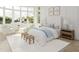 This main bedroom is complete with a rug, furniture, and large windows offering water views at 3621 San Remo Ter, Sarasota, FL 34239