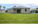 Rear view of house showcasing a large backyard at 23246 Stelling Ave, Port Charlotte, FL 33980