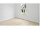 Bright bedroom with large window, neutral walls, and wood-look tile floors at 23246 Stelling Ave, Port Charlotte, FL 33980