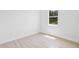 Simple bedroom with large window, neutral walls, and wood-look tile floors at 23246 Stelling Ave, Port Charlotte, FL 33980