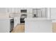 Modern kitchen with white cabinets, stainless steel appliances and an island at 23246 Stelling Ave, Port Charlotte, FL 33980