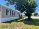 Tan mobile home with black shutters and a wooden staircase at 4772 Duncan Rd, Punta Gorda, FL 33982