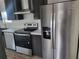 Modern kitchen featuring stainless steel appliances and dark cabinets at 4772 Duncan Rd, Punta Gorda, FL 33982
