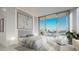 Comfortable bedroom with water views and seating at 223 Golden Gate Point # 9C, Sarasota, FL 34236