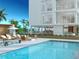 Resort-style pool with lounge chairs and fire pit at 223 Golden Gate Point # 9C, Sarasota, FL 34236