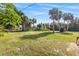 Expansive backyard with lush greenery and mature trees offering privacy at 301 Lambert St, Port Charlotte, FL 33948