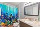Bathroom featuring a unique shower curtain and a faux marble countertop at 301 Lambert St, Port Charlotte, FL 33948