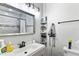 Clean bathroom featuring a gray vanity, shower, and decorative shelving at 301 Lambert St, Port Charlotte, FL 33948