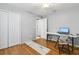 Comfortable bedroom featuring wood laminate floors, closet, and chair at 301 Lambert St, Port Charlotte, FL 33948