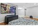 Bedroom with mounted television, hardwood floors, and entry into another room at 301 Lambert St, Port Charlotte, FL 33948