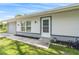 Close up of the entrance to the home, the front door has a white door and storm door at 301 Lambert St, Port Charlotte, FL 33948