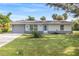 Charming single-story home with a well-maintained lawn and mature landscaping at 301 Lambert St, Port Charlotte, FL 33948