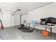 A peek at the garage area showing garage door, mechanic tools, and work table at 301 Lambert St, Port Charlotte, FL 33948
