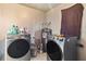 Modern laundry room with two new stainless steel washing machines at 301 Lambert St, Port Charlotte, FL 33948
