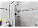 Bathroom shower with gray marbled tiles and a stone mosaic accent at 301 Lambert St, Port Charlotte, FL 33948