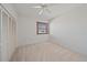 This is a bedroom that has neutral carpet, a ceiling fan and a bright window with blinds at 1654 Starling Dr # 201, Sarasota, FL 34231