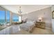 Bright bedroom with ocean view and chaise lounge at 1300 Benjamin Franklin Dr # 701, Sarasota, FL 34236