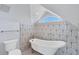 Bathroom features a clawfoot tub and geometric tile at 1910 Oregon Trl, Englewood, FL 34224
