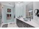 Elegant bathroom with double sinks, a large shower, and modern fixtures at 1910 Oregon Trl, Englewood, FL 34224
