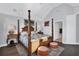 Spacious main bedroom with a large four poster bed at 1910 Oregon Trl, Englewood, FL 34224