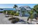 Two story waterfront home with metal roof and paver driveway at 1910 Oregon Trl, Englewood, FL 34224